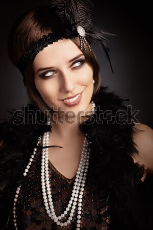 Beautiful retro woman in 20s style party outfit Stock photo © NicoletaIonescu