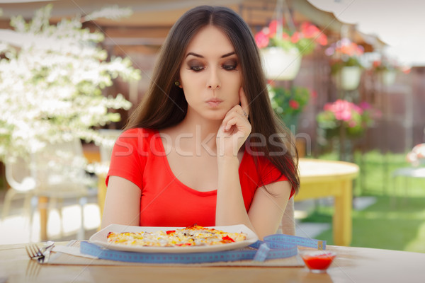 Young Woman Thinking About Eating Pizza on a Diet  Stock photo © NicoletaIonescu