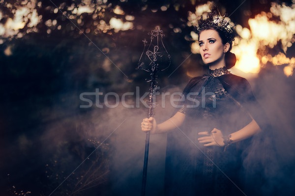 Evil Queen Holding Scepter in Misty Forest Stock photo © NicoletaIonescu