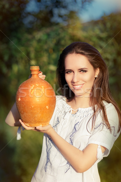 Young Woman with Clay Pitcher  Stock photo © NicoletaIonescu