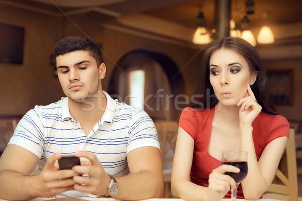 Curious Girl Spying Boyfriend on Smartphone Stock photo © NicoletaIonescu