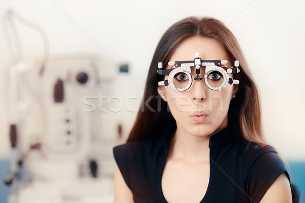 Funny Girl at Ophthalmological Exam Wearing Eye Test Glasses  Stock photo © NicoletaIonescu