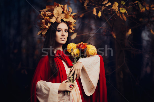 Beautiful Woman With Autumn Leaves Crown Holding Flowers  Stock photo © NicoletaIonescu