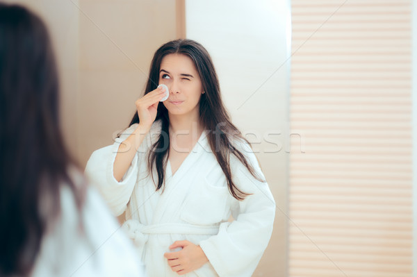 Woman in Bathrobe Cleaning Her Face with Make-up Remover Stock photo © NicoletaIonescu
