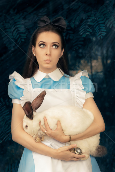 Funny Girl Costumed as Alice in Wonderland with The White Rabbit Stock photo © NicoletaIonescu