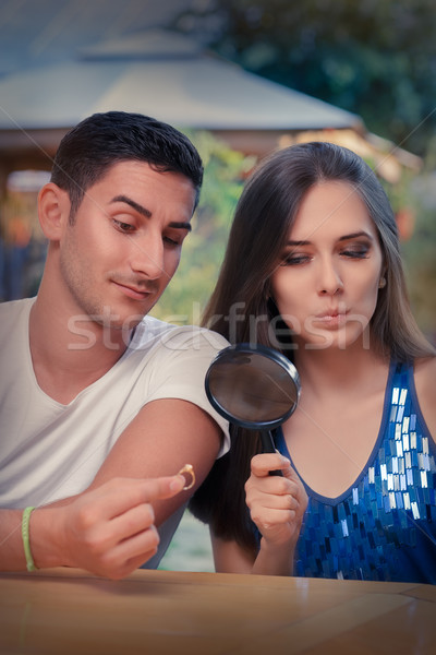 Curious Girl Testing Engagement Ring from Boyfriend with Magnifier Stock photo © NicoletaIonescu