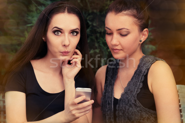 Young Women Surprised by Text Message  Stock photo © NicoletaIonescu