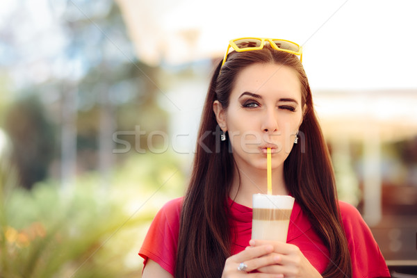 Cool Girl Winking and Sipping Summer Coffee Drink  Stock photo © NicoletaIonescu