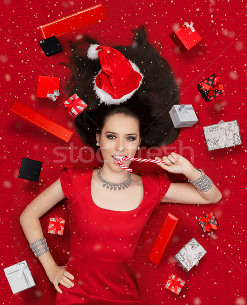 Funny Christmas Girl with Candy Cane surrounded by Presents  Stock photo © NicoletaIonescu