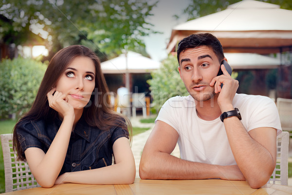 Girl Feeling Bored while her Boyfriend is on The Phone Stock photo © NicoletaIonescu