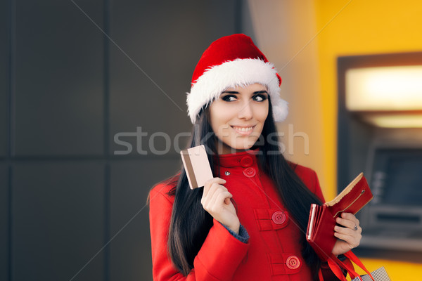 Happy Shopping Woman Holding Credit Card in front of an ATM Stock photo © NicoletaIonescu