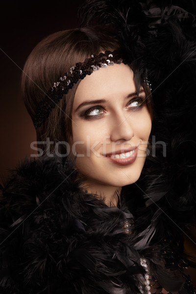 Beautiful retro woman in 20s style party outfit Stock photo © NicoletaIonescu