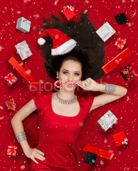 Funny Christmas Girl with Candy Cane surrounded by Presents  Stock photo © NicoletaIonescu