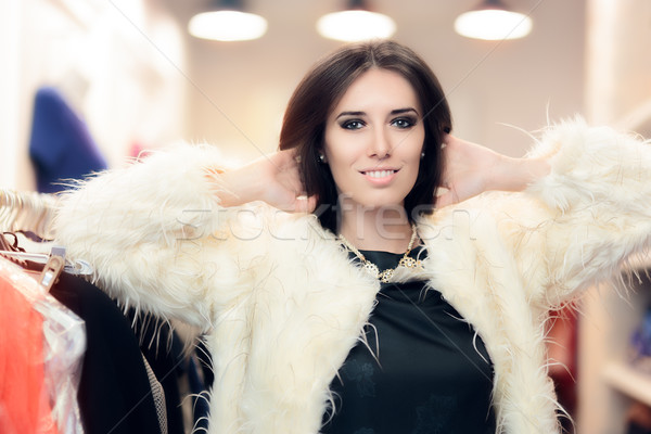 Shopping Woman Dressed in White Fur Coat in Fashion Store Stock photo © NicoletaIonescu