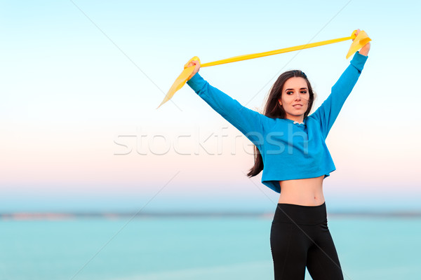 Fitnessz lány képzés jóga gumi rugalmas Stock fotó © NicoletaIonescu