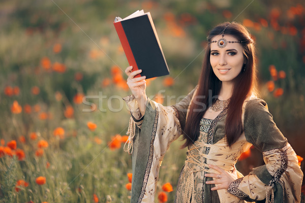 Stock photo: Medieval Reading a Book in a Magical Field of Poppies