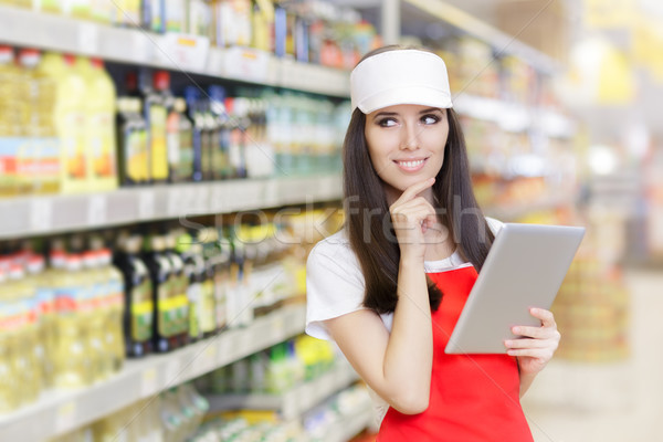 Smiling Supermarket Employee Holding a Pc Tablet Stock photo © NicoletaIonescu