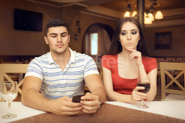 Curious Girl Spying Boyfriend on Smartphone Stock photo © NicoletaIonescu