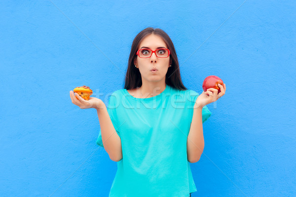 Woman Choosing Between Unhealthy Muffin and Healthy Apple Stock photo © NicoletaIonescu