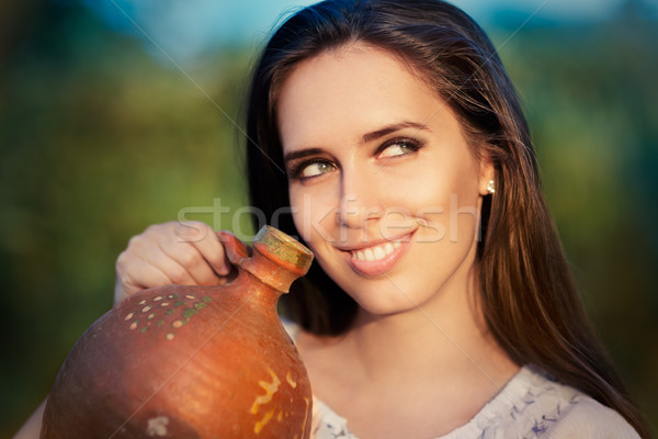 Young Woman with Clay Pitcher  Stock photo © NicoletaIonescu