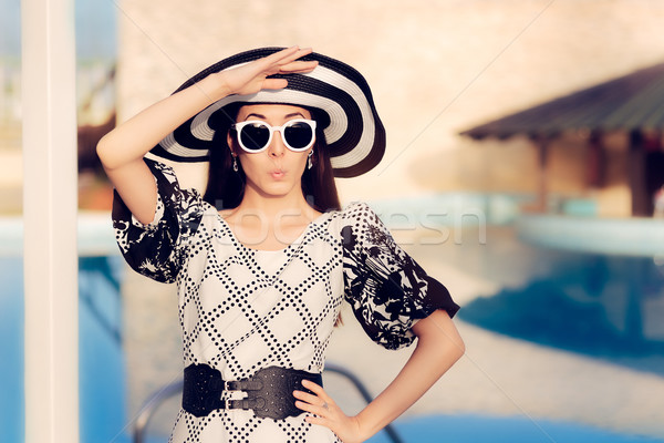 Surprised  Woman With Sunglasses and Sun Hat by the Pool  Stock photo © NicoletaIonescu