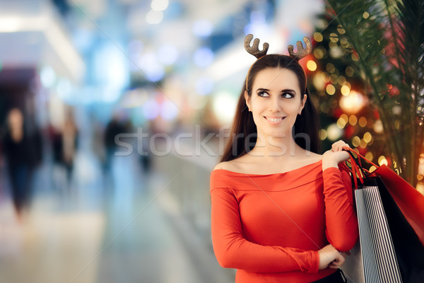 Shopping Woman Wearing Christmas Reindeer Horns Headband Stock photo © NicoletaIonescu
