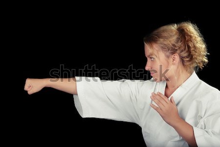 Profile of a Young Karate Woman Wearing Kimono in Martial Art Pose  Stock photo © NicoletaIonescu