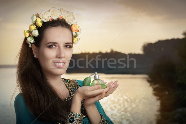 Young Woman Holding Perfume Bottle in Sunlight   Stock photo © NicoletaIonescu