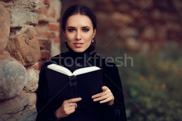 Gyönyörű sötét hercegnő olvas könyv portré Stock fotó © NicoletaIonescu