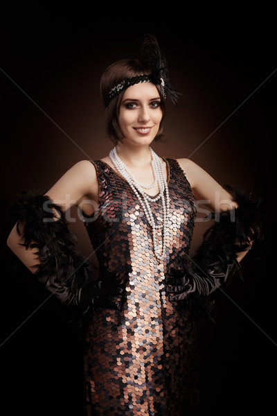 Beautiful retro woman from the roaring 20s ready to party Stock photo © NicoletaIonescu