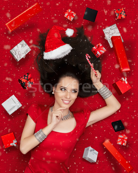Happy Christmas Girl Holding Candy Cane surrounded by Presents  Stock photo © NicoletaIonescu