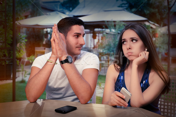 Young Couple Having Problems with Their Smart Phones  Stock photo © NicoletaIonescu
