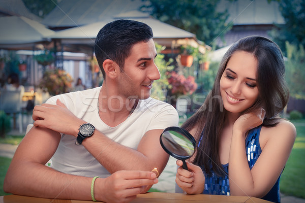 Stock photo: Happy Woman Testing Engagement Ring from Boyfriend with Magnifier