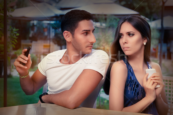 Secretive Couple with Smart Phones in Their Hands  Stock photo © NicoletaIonescu