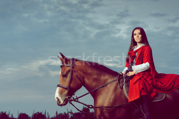 Beautiful Princess with Red Cape Riding a Horse  Stock photo © NicoletaIonescu