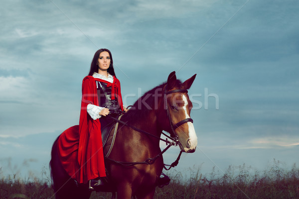 Beautiful Princess with Red Cape Riding a Horse  Stock photo © NicoletaIonescu