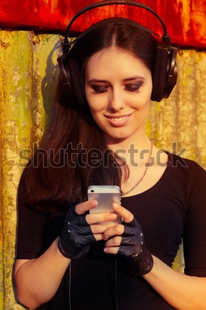 Girl with Big Headphones and Smart Phone on Grunge Background  Stock photo © NicoletaIonescu