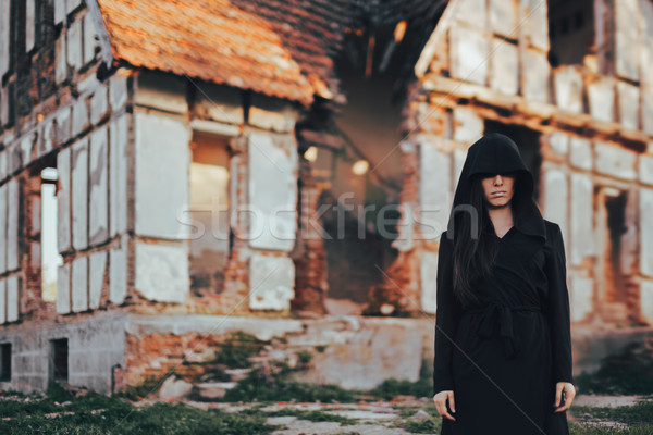 Stock photo: Mysterious Evil Spirit in Front of a Horror Abandoned House