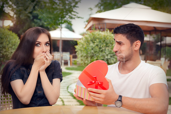 Happy Girl Receiving Heart Shaped Gift from her Boyfriend  Stock photo © NicoletaIonescu