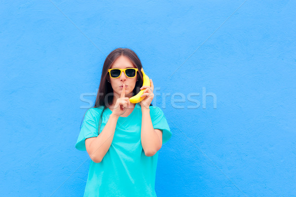 Funny Girl with Sunglasses and Banana Phone on Blue Background Stock photo © NicoletaIonescu