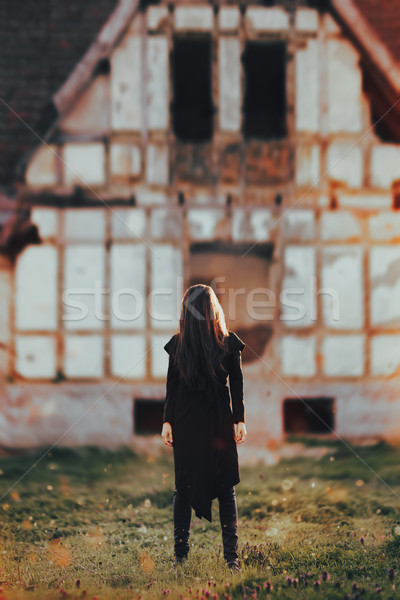 Stock photo: Evil Ghost in Front of a Horror Haunted Abandoned House