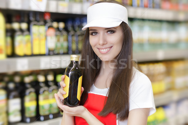 Smiling Supermarket Employee Holding a Product Stock photo © NicoletaIonescu