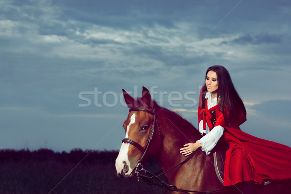 Beautiful Princess with Red Cape Riding a Horse  Stock photo © NicoletaIonescu