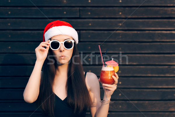 Girl with Sunglasses Holding Cocktail Drink at Christmas Party Stock photo © NicoletaIonescu