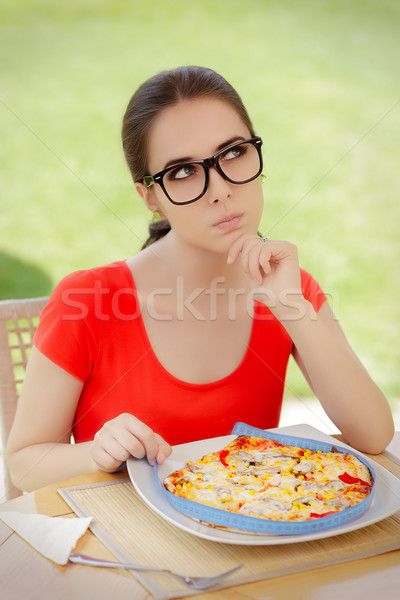 Thoughtful Woman Measures Pizza with Measure Tape  Stock photo © NicoletaIonescu