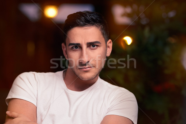 Surprised Young Man Sitting in a Restaurant Stock photo © NicoletaIonescu