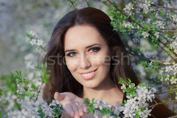 Woman with Allergy Holding Anti Allergic Pills in Spring Blooming Decor Stock photo © NicoletaIonescu