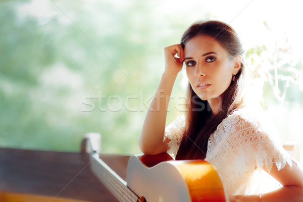 Portrait of a Beautiful Woman next to Her Guitar Stock photo © NicoletaIonescu