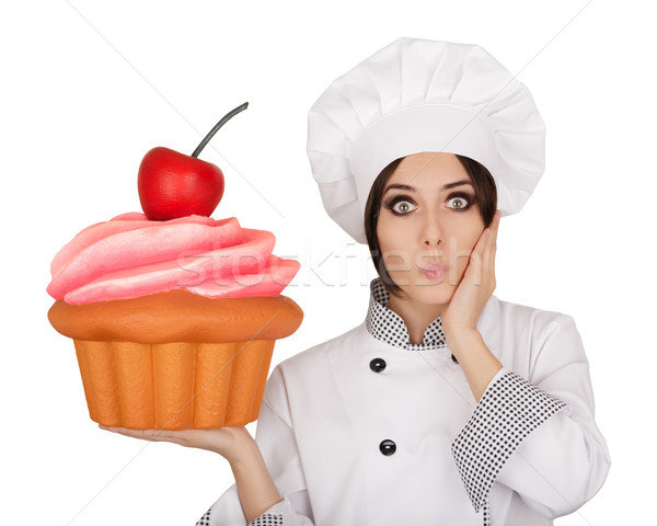 Amazed Woman Pastry Chef Holding Huge Cupcake Stock photo © NicoletaIonescu