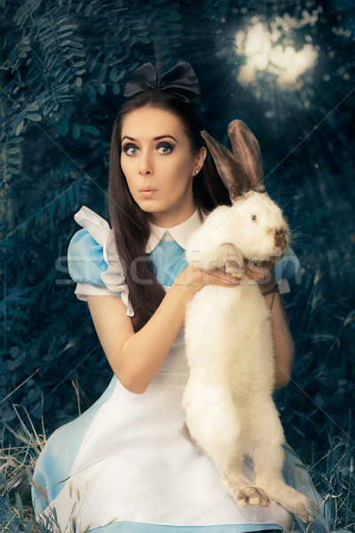 Stock photo: Funny Girl Costumed as Alice in Wonderland with The White Rabbit
